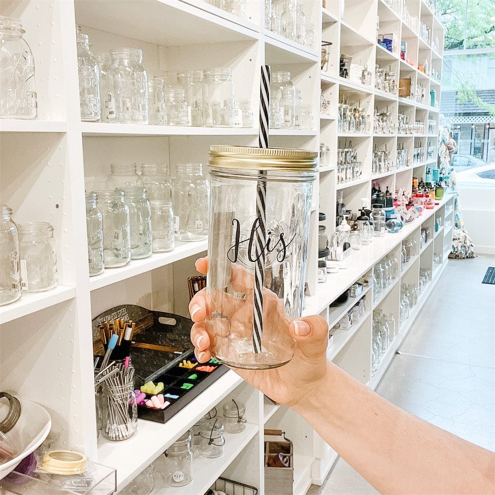 Wide angle of a mason jar tumbler that says “his” in a mason jar store.