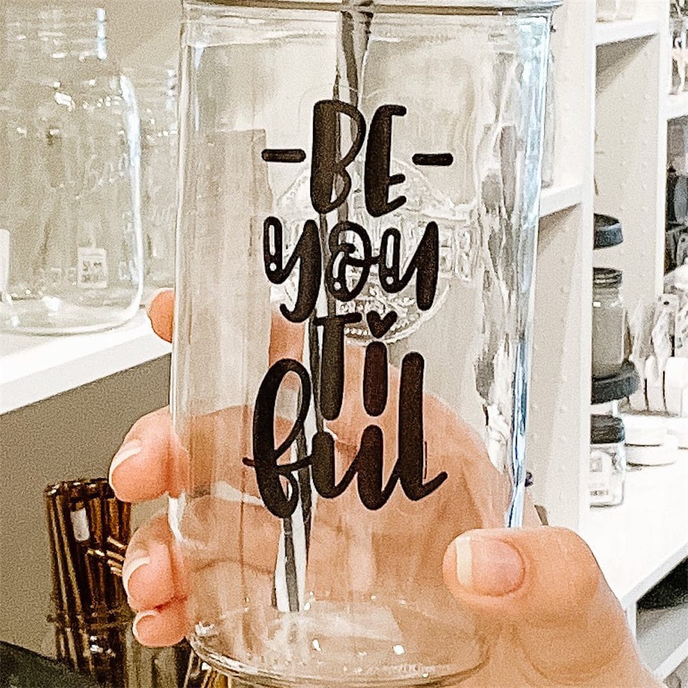 A photo of a mason jar tumbler with a sticker text that says "Be-YOU-ti-ful"