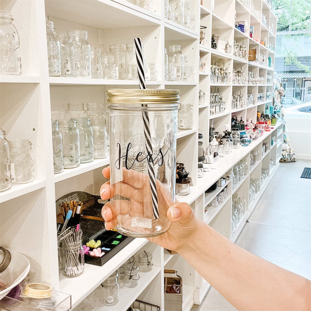 Wide angle of a mason jar tumbler that says “hers” in a mason jar store.