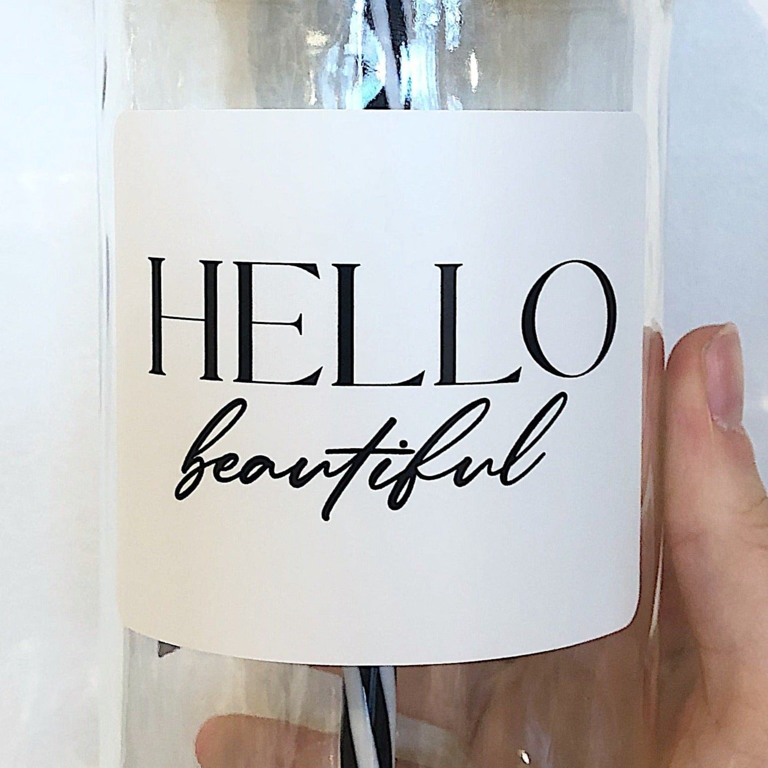 Mason jar tumbler that says “Hello beautiful” in black on a white background