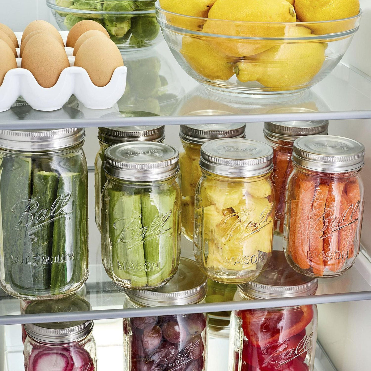 mason jars in a fridge with fruits and veggies inside and stainless steel, one-piece lids screwed on top