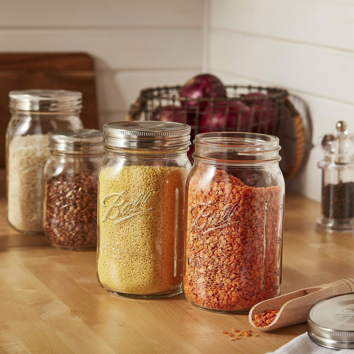 mason jars with grains in them and stainless steel, one-piece lids screwed on top