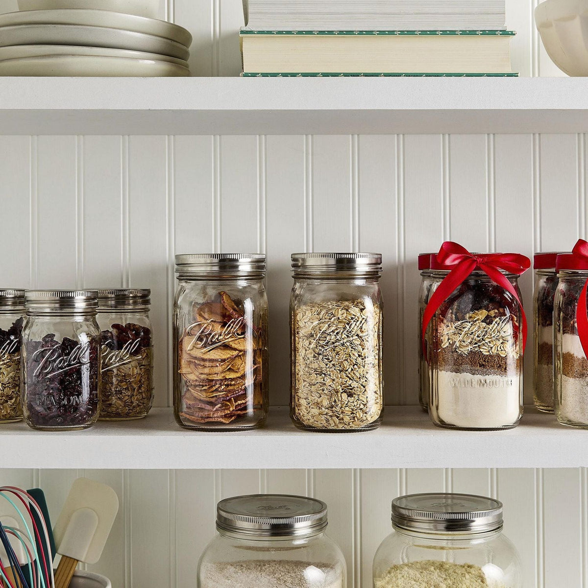 mason jars in a pantry with various things inside, and stainless steel , one-piece lids screwed on top