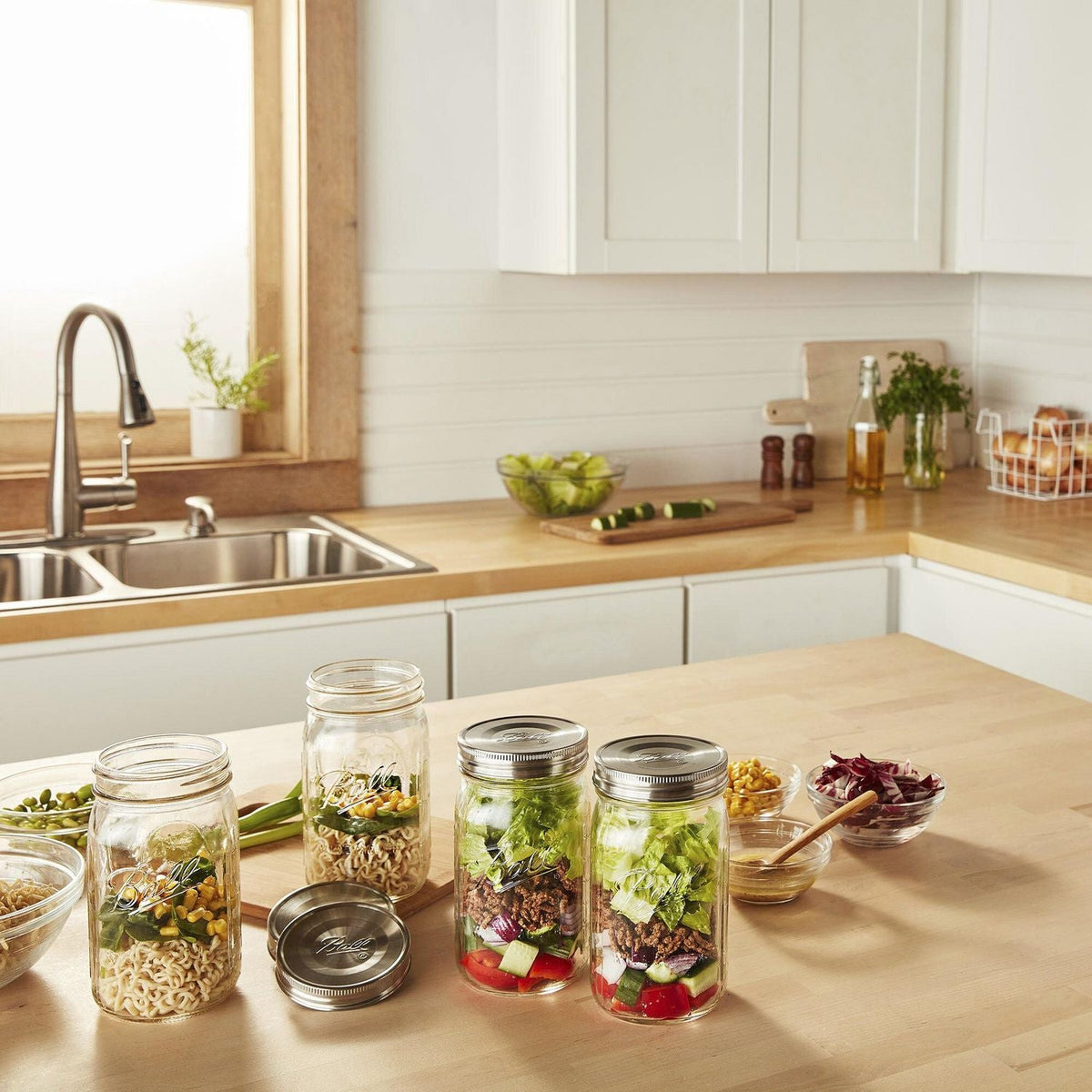 salads in mason jars with one-piece, stainless steel lids on top