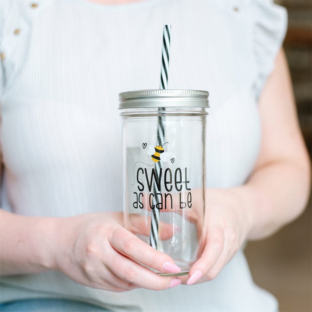Photo of a mason jar tumbler with a print of a bee and a text that says "sweet as can be".