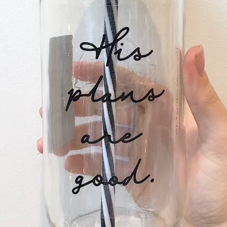 Close up of a mason jar tumbler that says "his plans are good” in black
