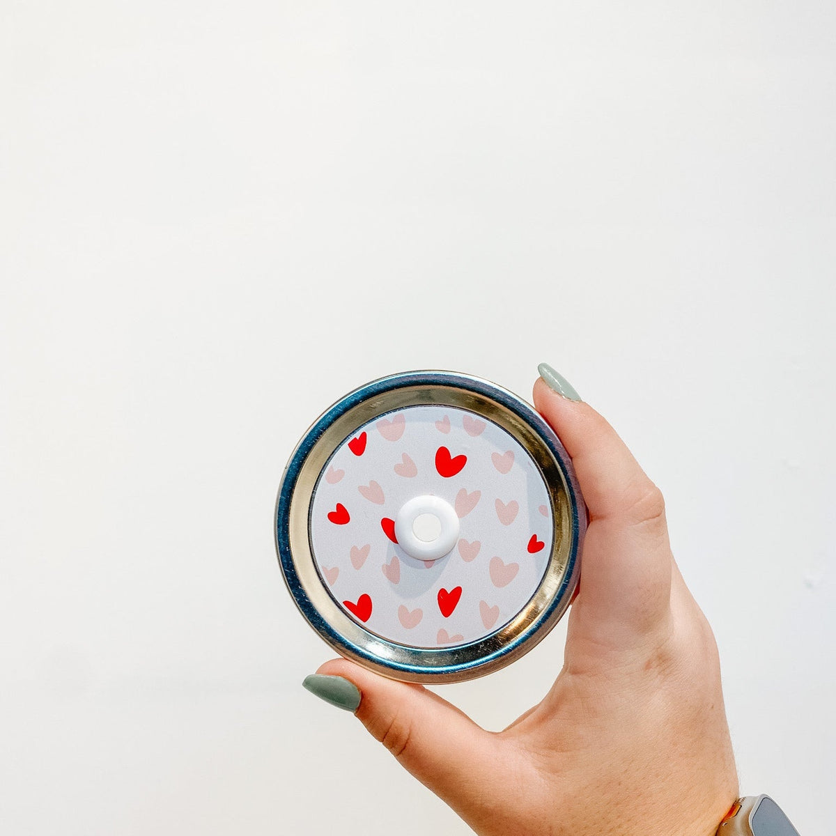straw lid with red and pink hearts on a light pink background