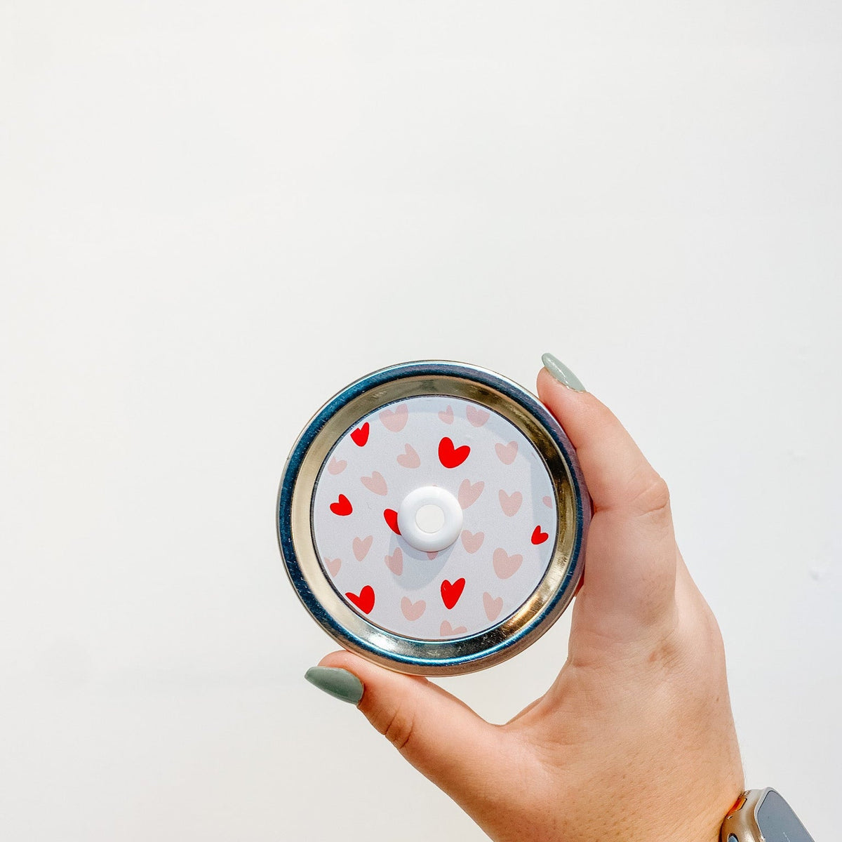 straw lid with red and pink hearts on a light pink background