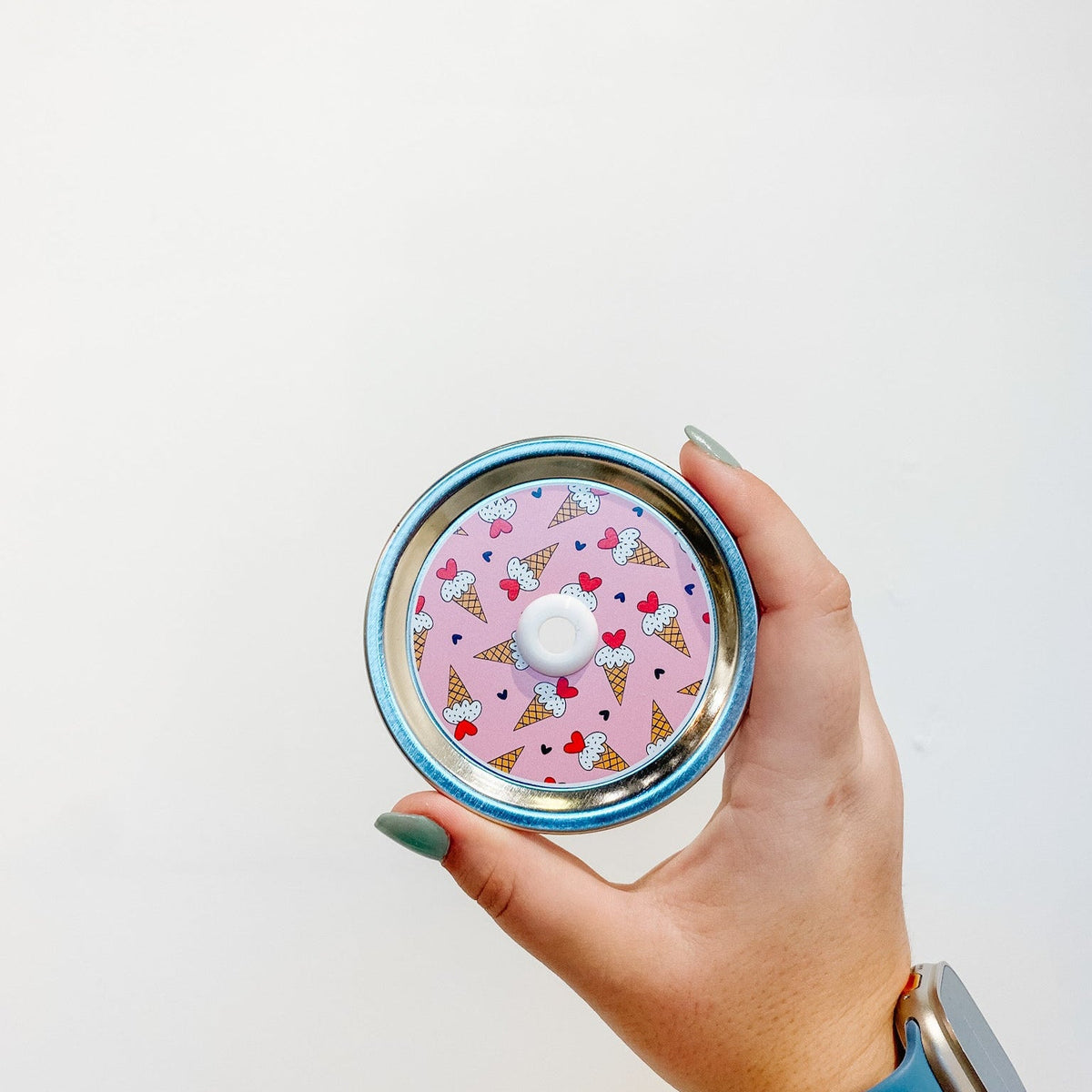 straw lid with ice cream cones on a pink background