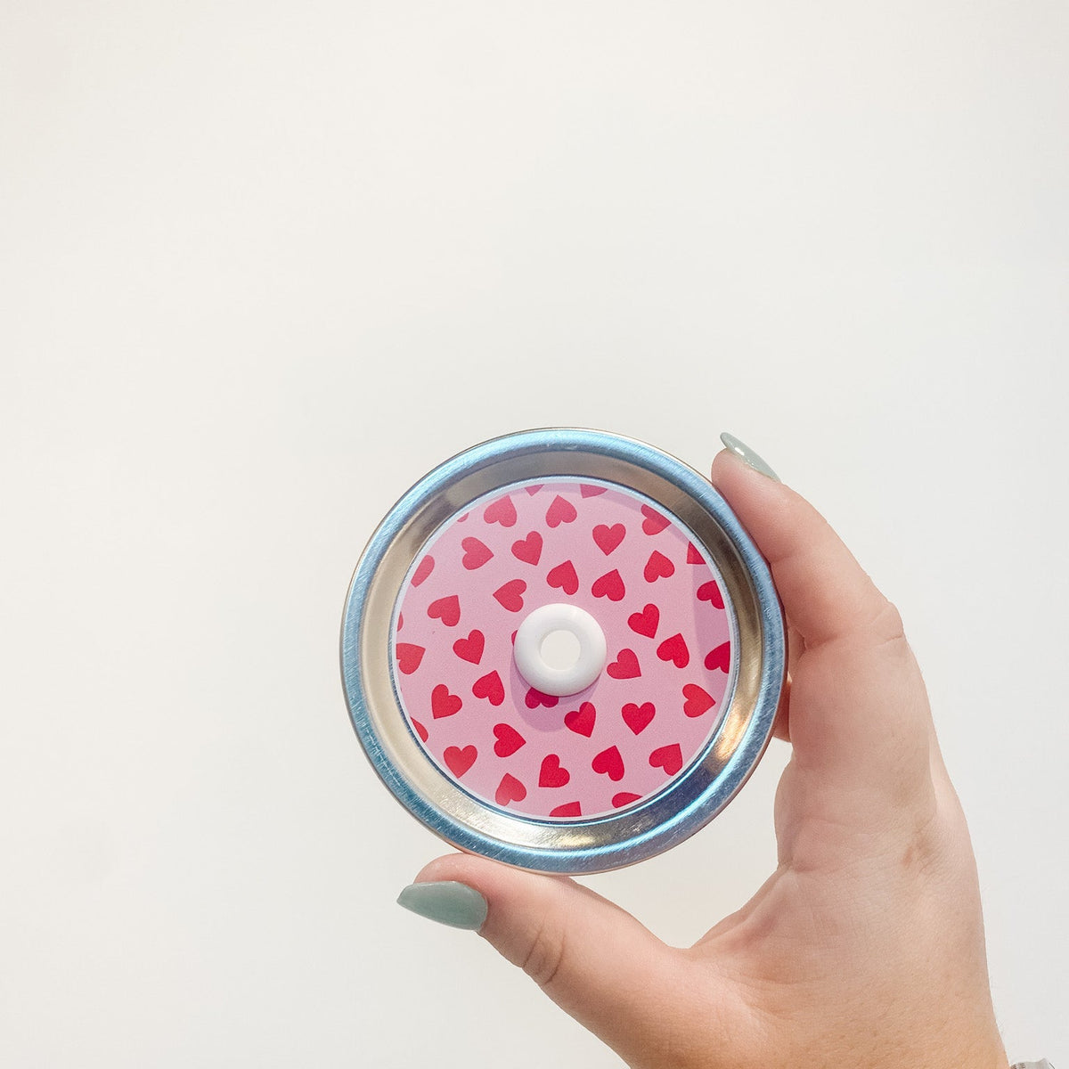 straw lid with red hearts on a pink background