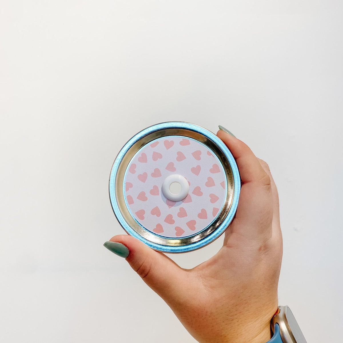 straw lid with pink hearts on a light ink background