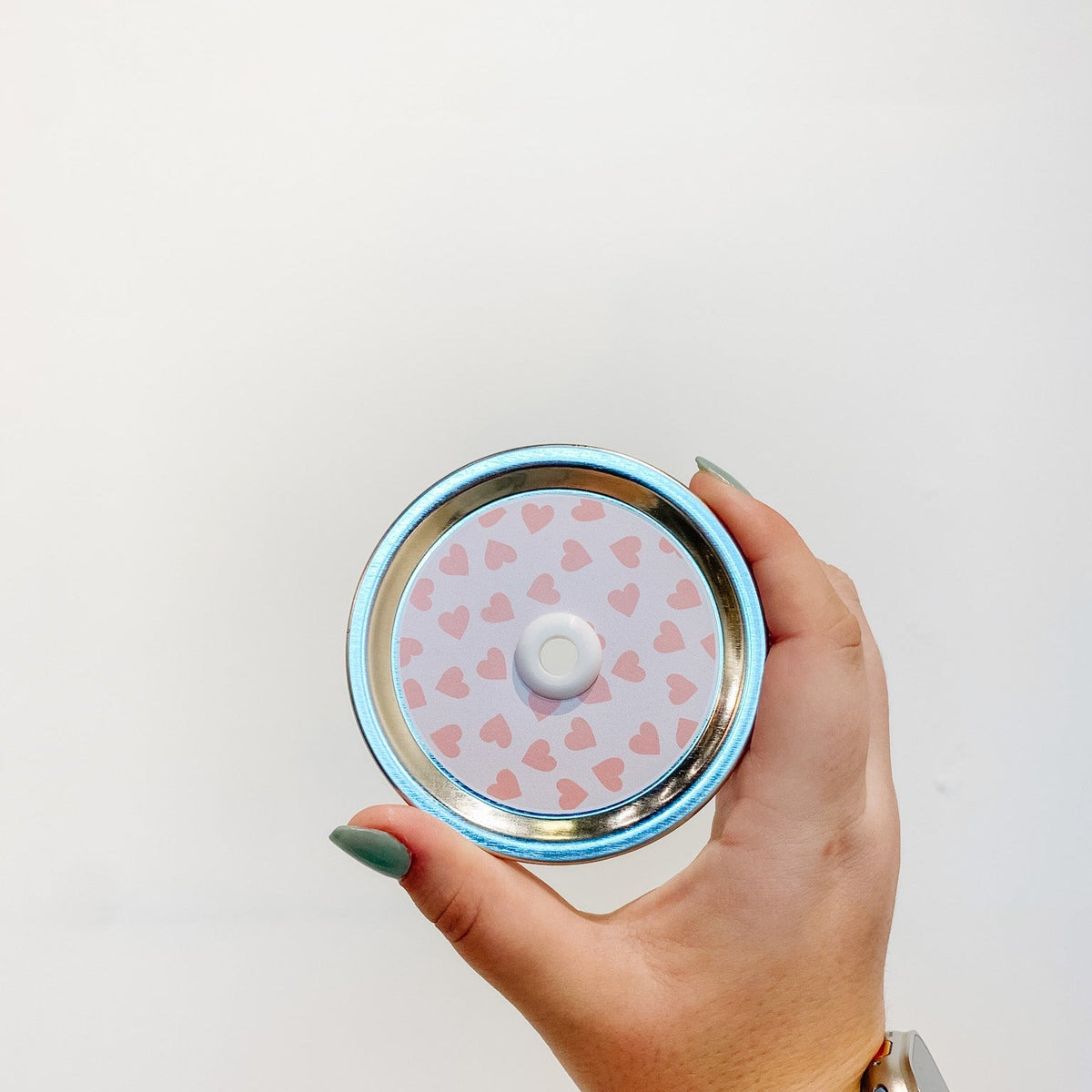 straw lid with pink hearts on a light pink background
