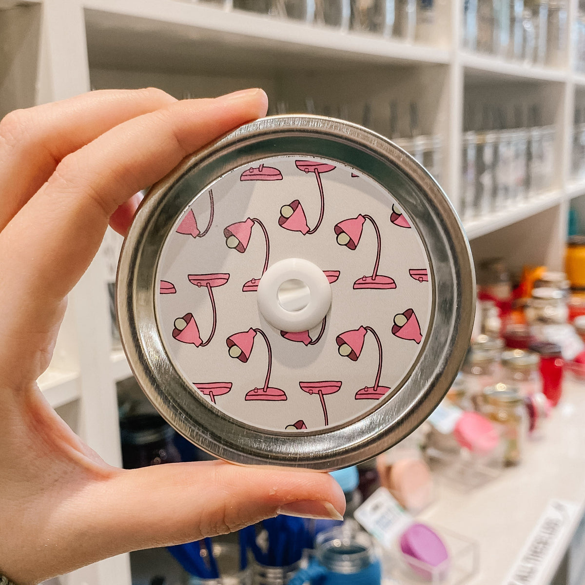 straw lid with a white background and a pink desk lamp repeating pattern
