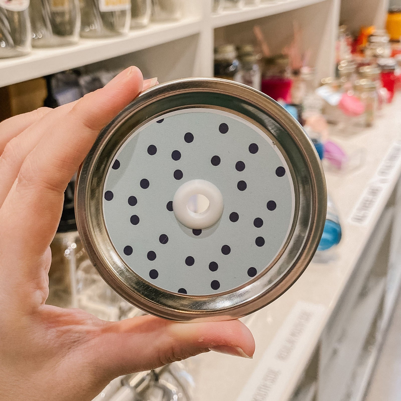 straw lid that has an aqua background with small black polka dots