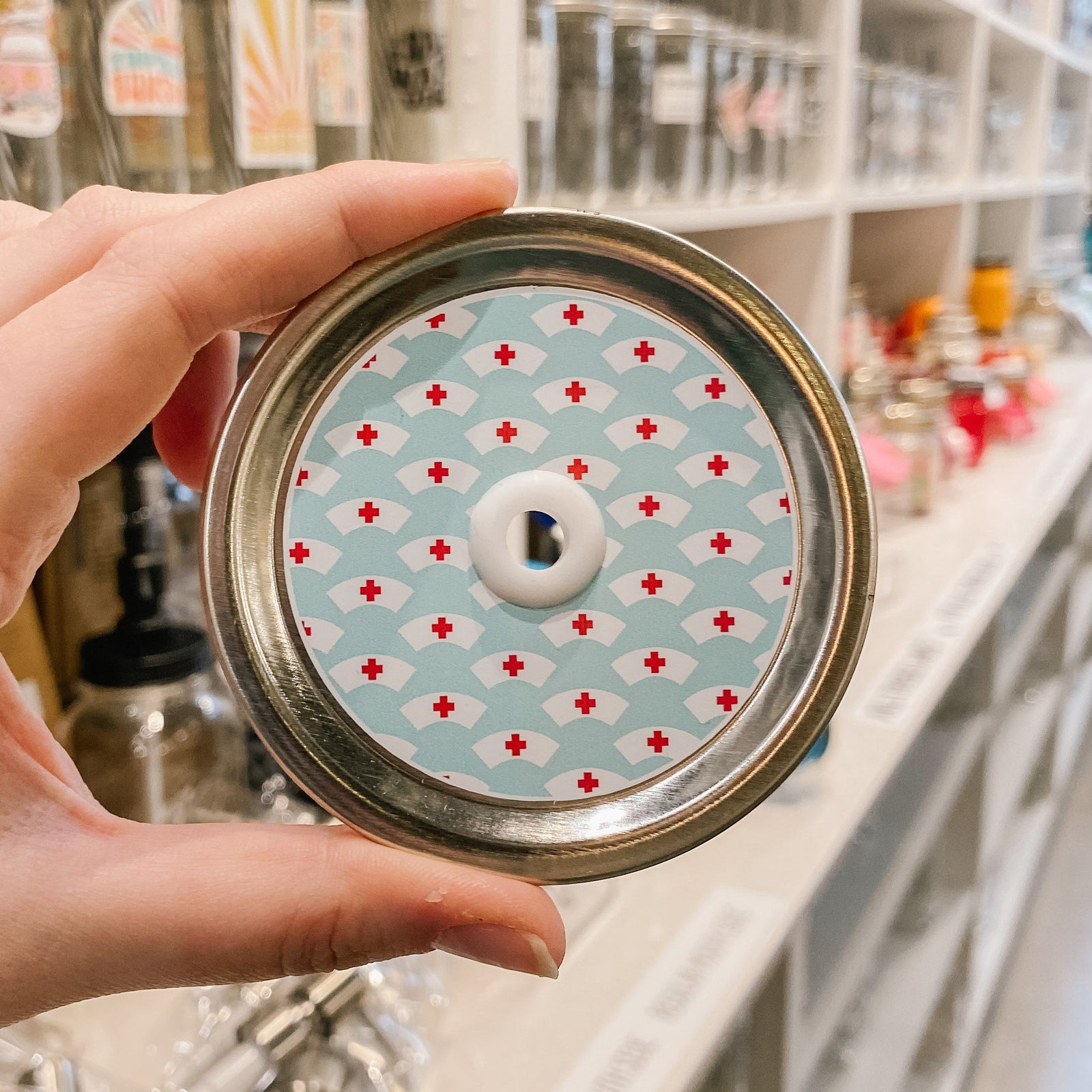 straw lid with a light blue background and white nurse hats with red crosses