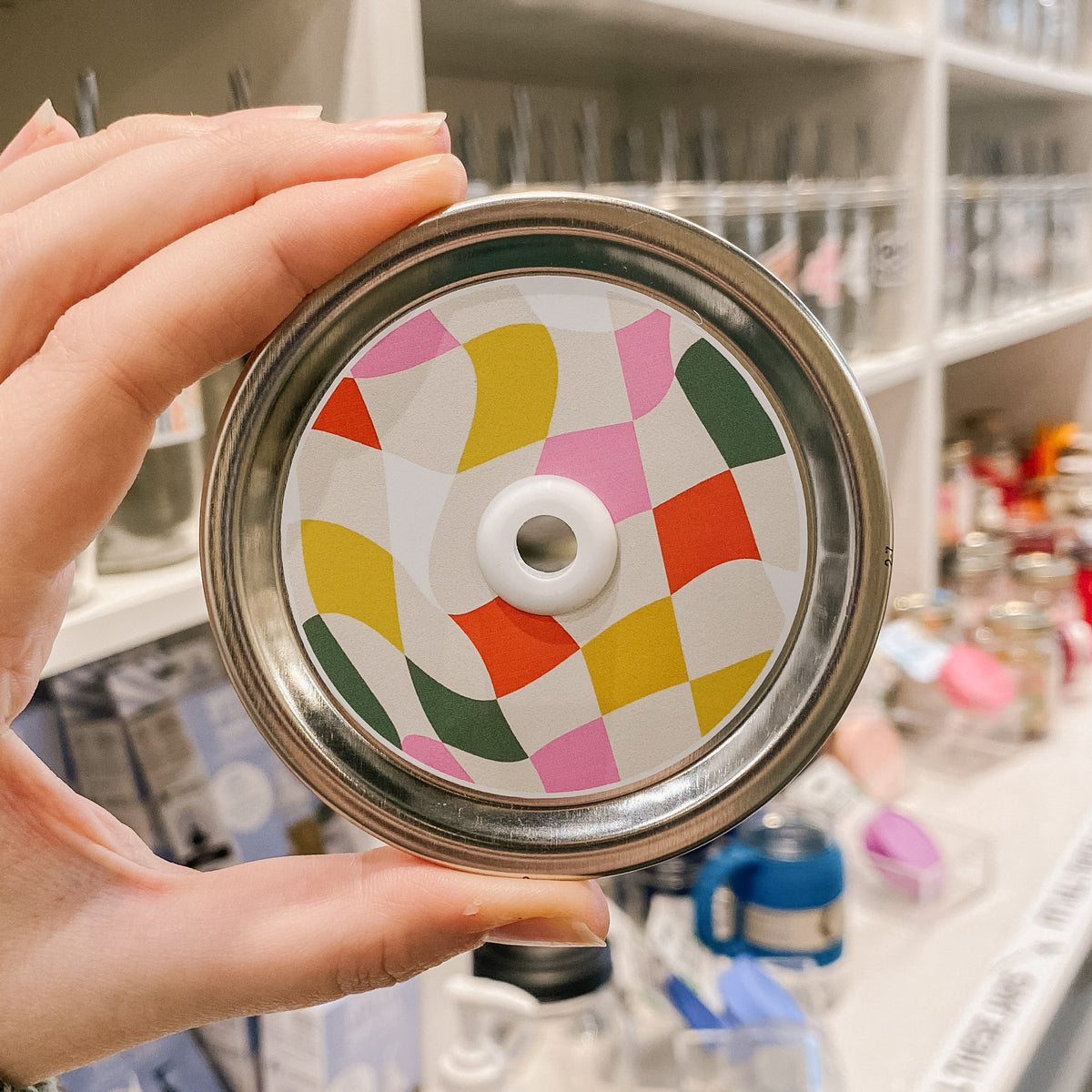 straw lid with a wavy grid of yellow, taupe, pink, white, green, and orange