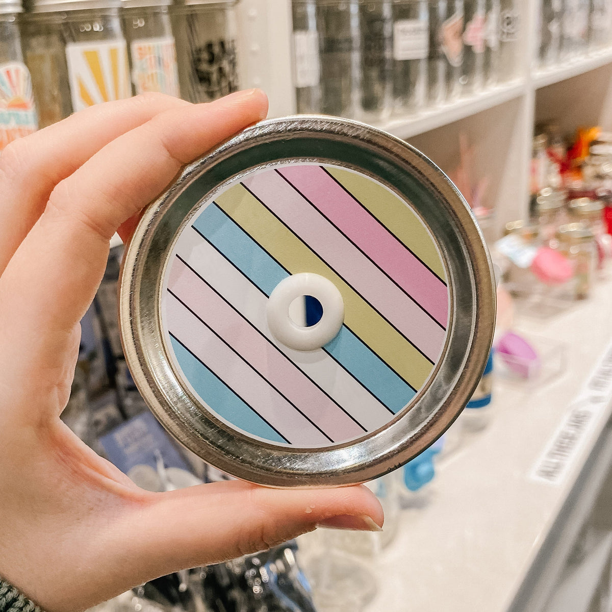 straw lid with think lines in blues, pinks, yellows, white