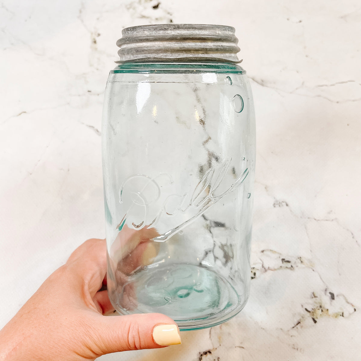 a light blue ball mason jar with a vintage zinc lid