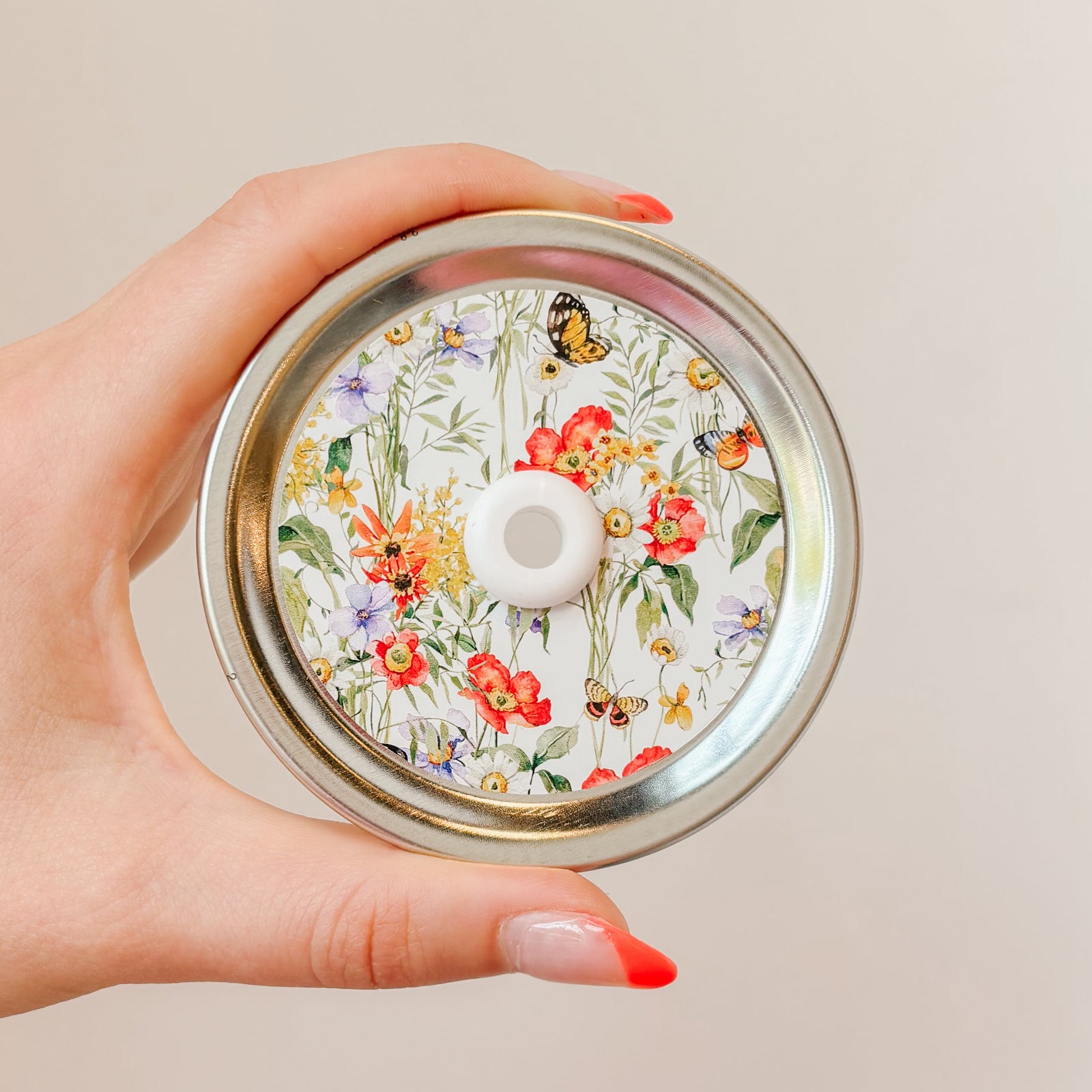 straw lid with a white background, cluttered with leaves, flowers, and butterflies