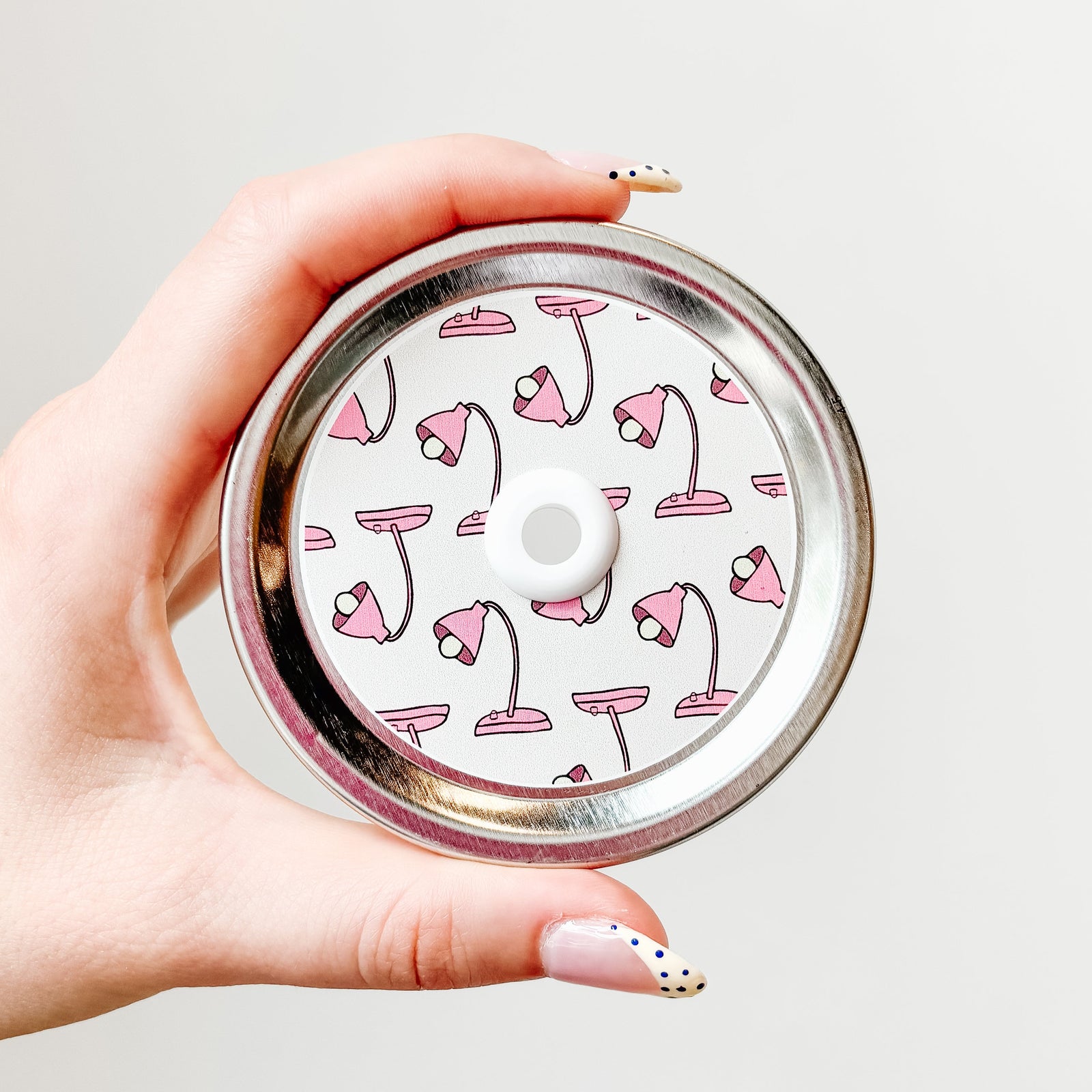 straw lid with a white background and a pink desk lamp repeating pattern