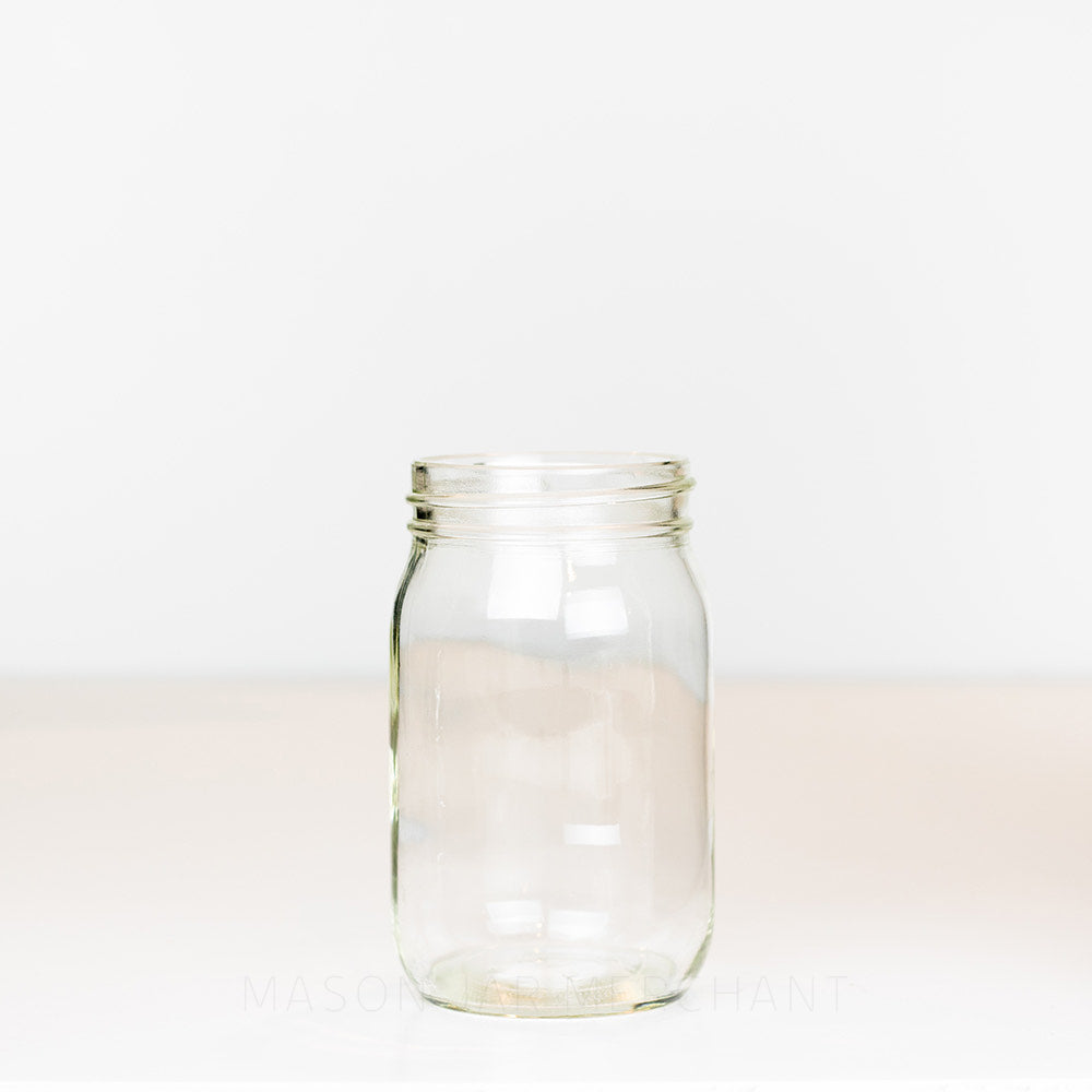 Regular mouth pint mason jar with plain sides, no markings, on a white background