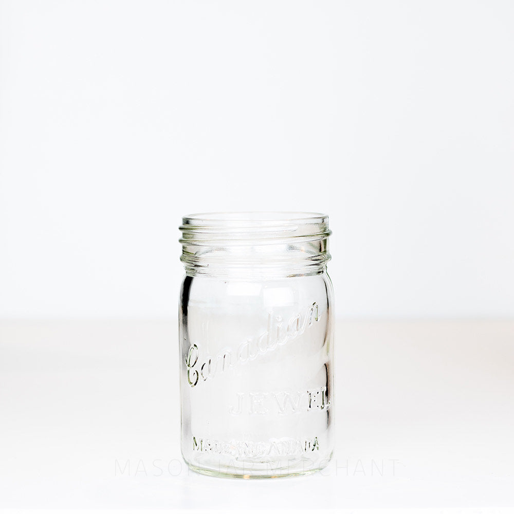 Vintage gem mouth pint mason jar with Canadian Jewel logo on a white background