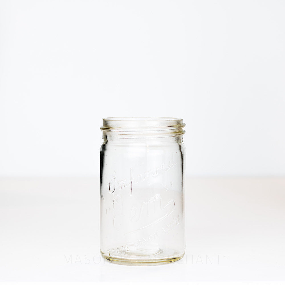 Vintage gem mouth pint mason jar with Improved Gem logo, on a white background