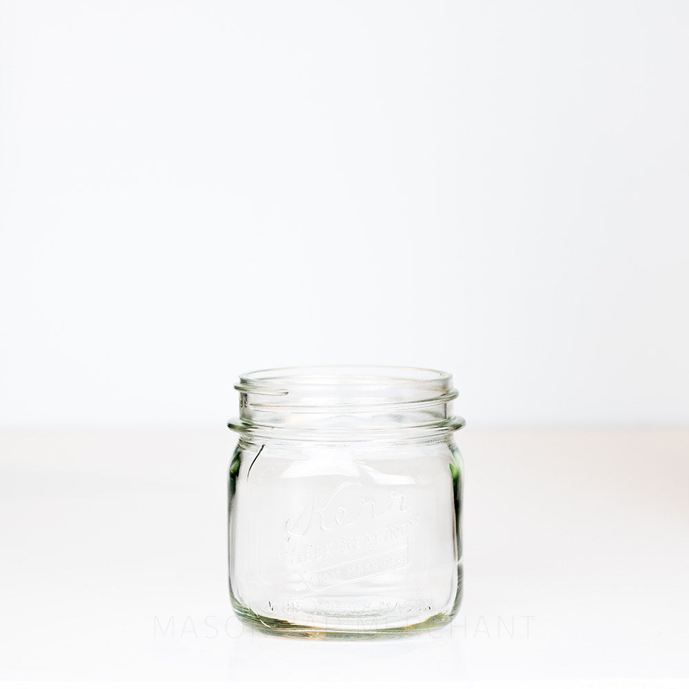 Vintage Kerr Self Sealing Short Square Wide Mouth Pint Mason Jar on a white background.
