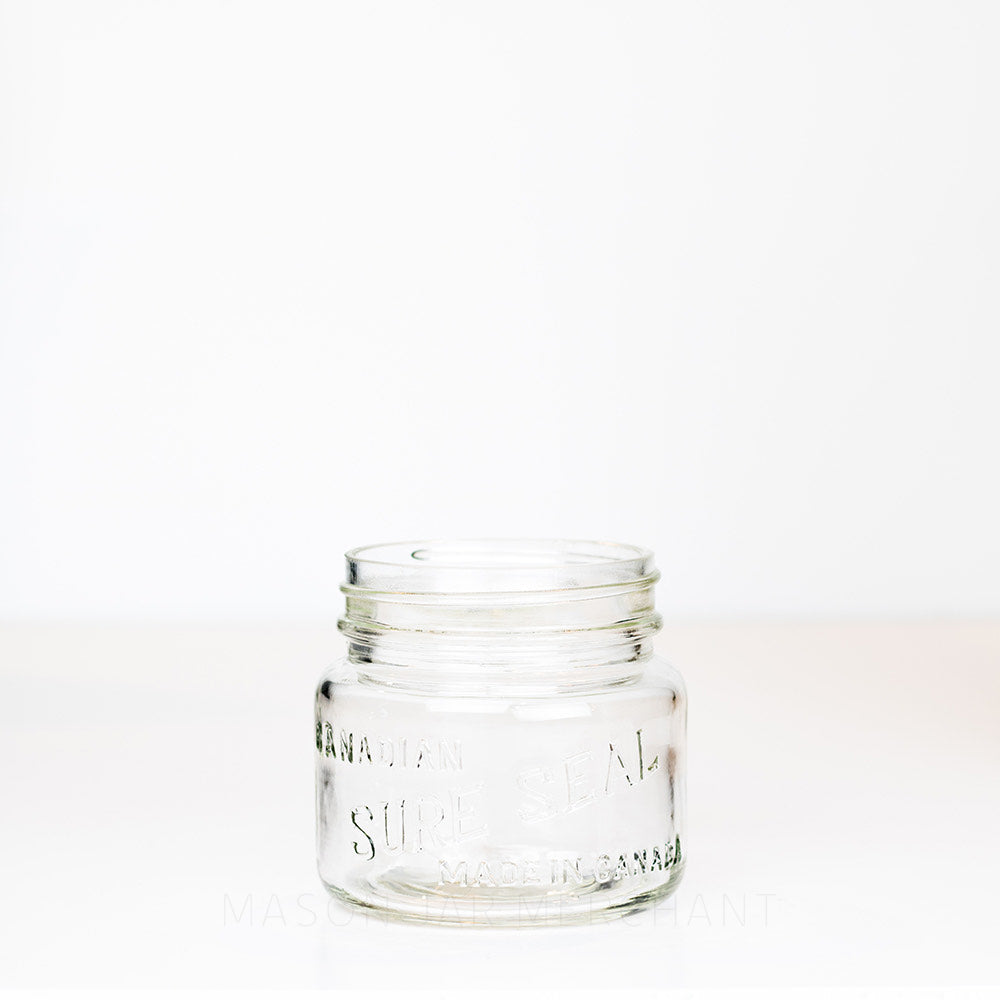 Vintage wide mouth pint mason jar with Canadian Sure Seal logo, against a white background