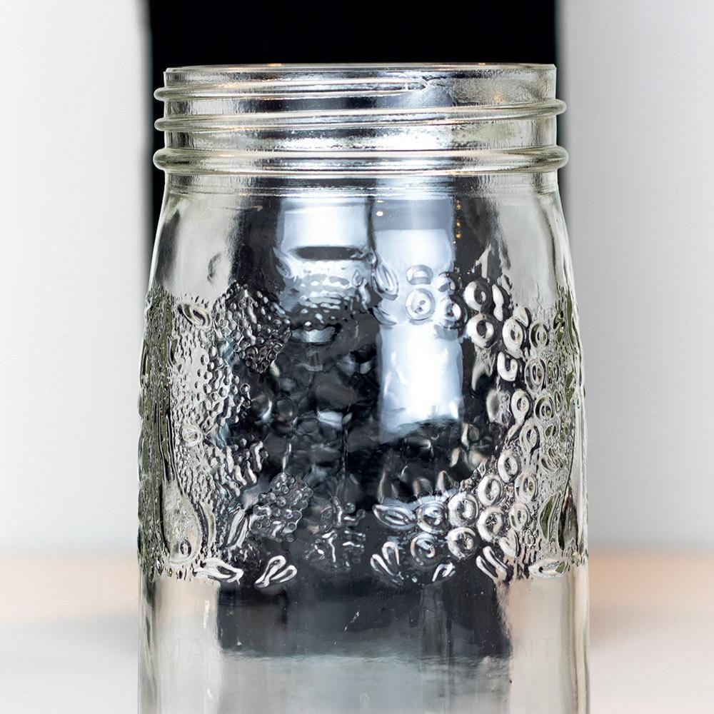 close up of a Fruity lace round wide mouth quart mason jar on a white background