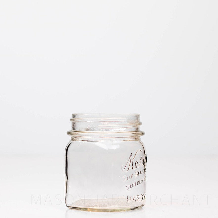 Regular mouth half-pint mason jar with Kerr self-sealing logo, against a white background
