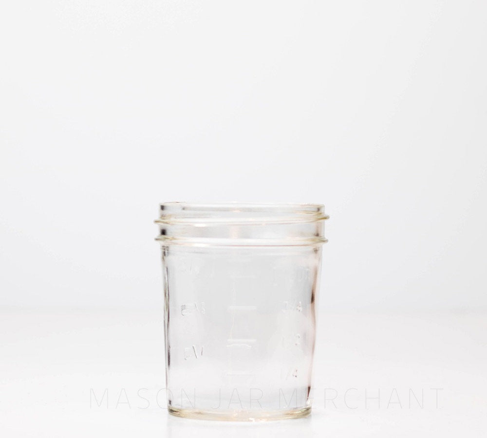 Regular mouth half pint mason jar with straight sides against a white background