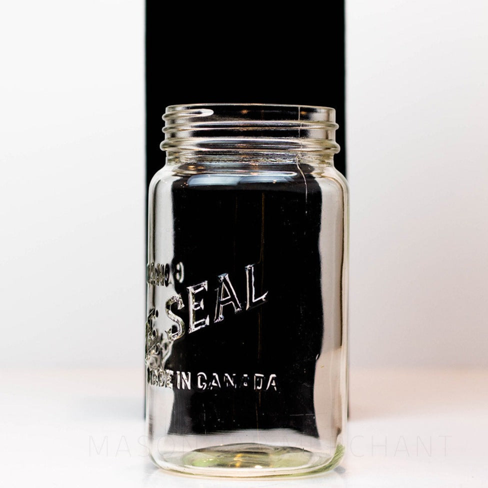 A close up of a Canadian Sure Seal wide mouth quart mason jar against a white background