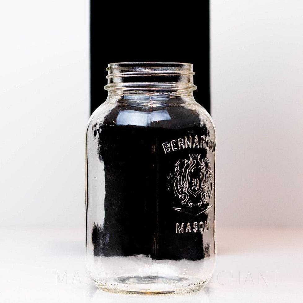 Side view of a Regular mouth shield half gallon reusable mason jar with Bernadin logo against a white background