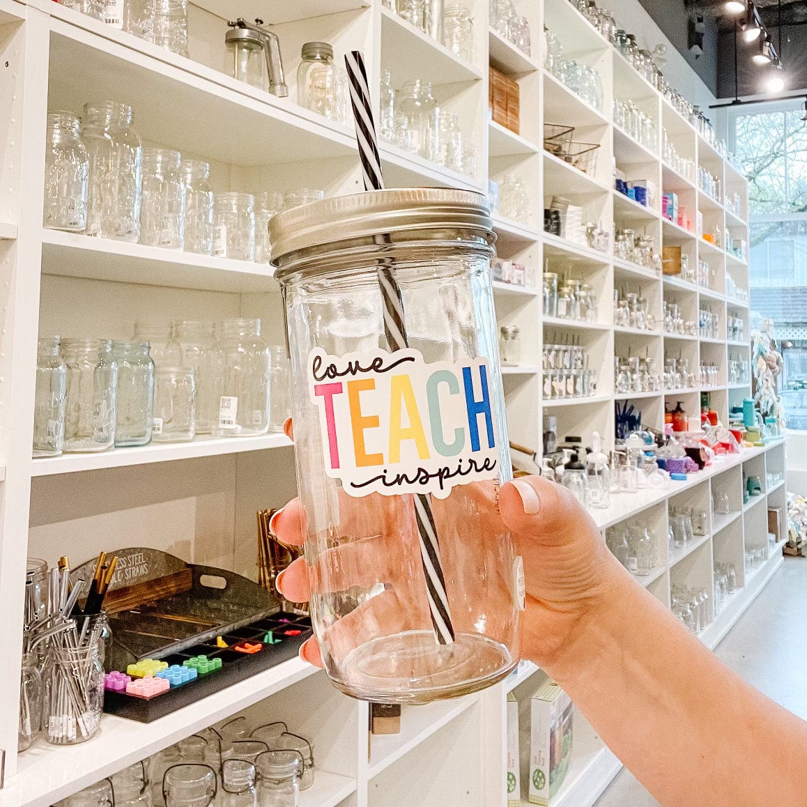 Mason jar tumbler with a "Love TEACH inspire" text