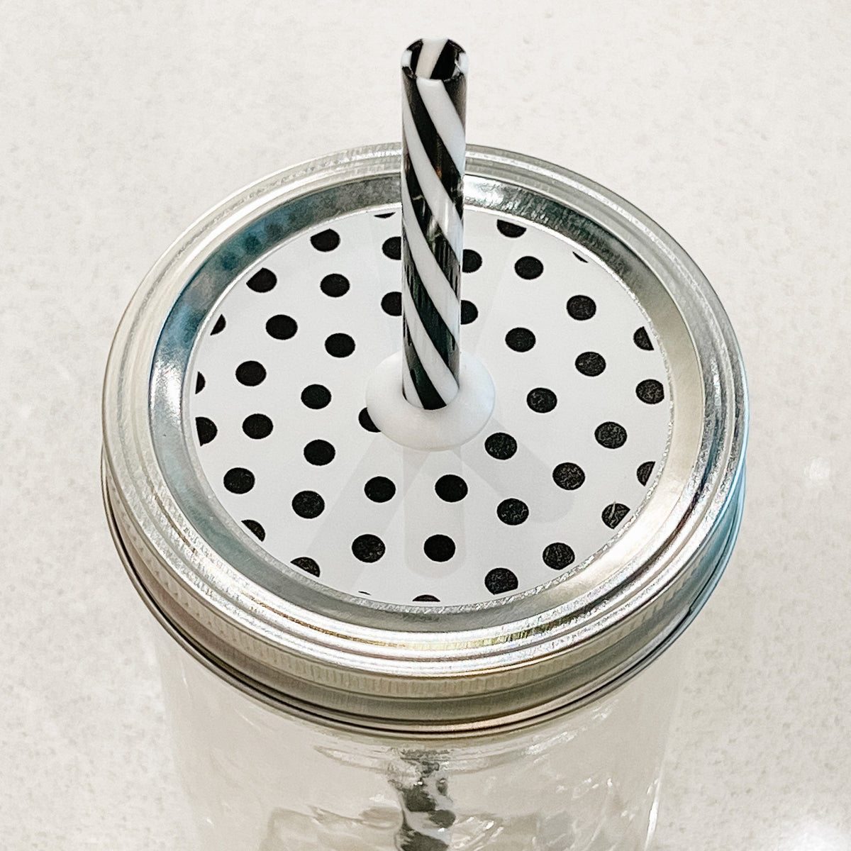 top photo of mason jar lid with black polka dots
