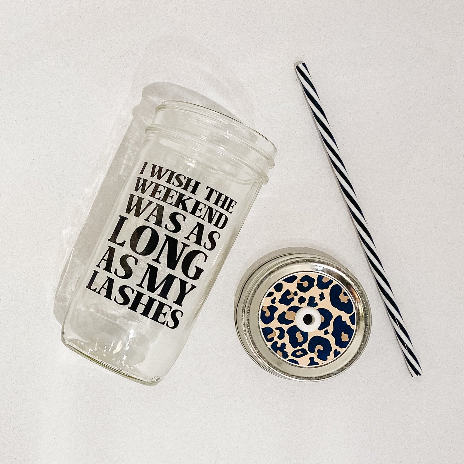 Hand holding a mason jar tumbler that says "I wish the weekend was as long as my lashes”