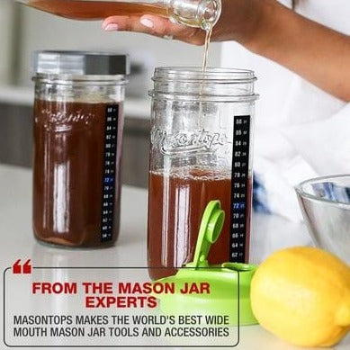 Two tall mason jars filled with kombucha and has a slogan that says "From the mason jar experts"
