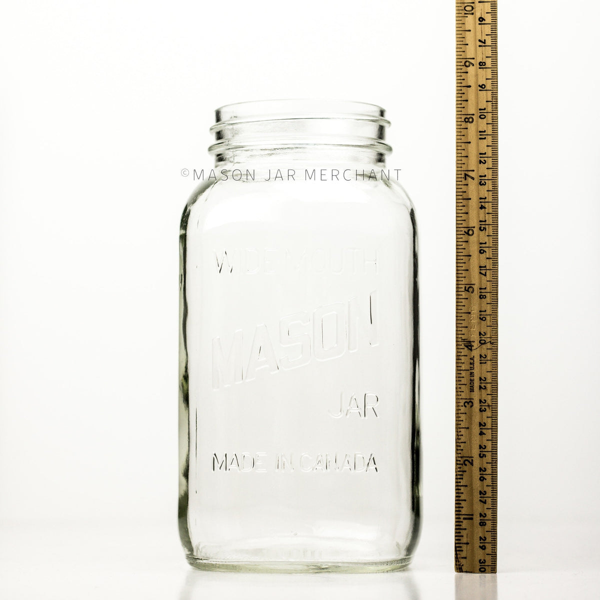 Wide mouth half-gallon mason jar with Mason logo with a meter stick beside it and is shown against a white background