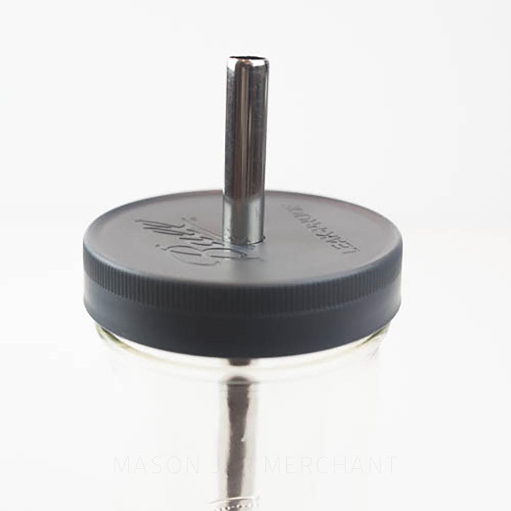 close up of an all black plastic mason jar Ball straw lid on a glass mason jar with a black metal straw in it