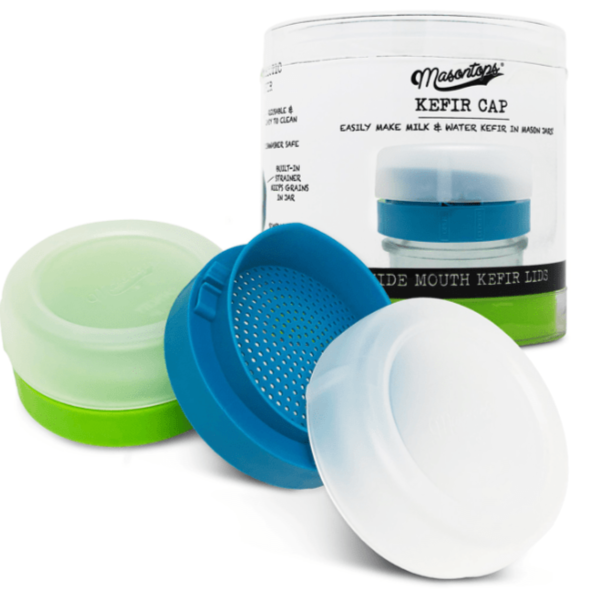 Two mason jar kefir lids sit on a white background. One jar is green and the other is blue