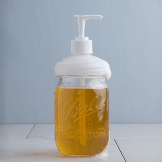 a white reCap mason jar pump lid on a regular mouth jar on a white background