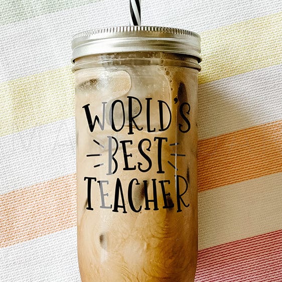 Zoomed in tumbler with iced coffee with sticker that says "World's Best Teacher.".