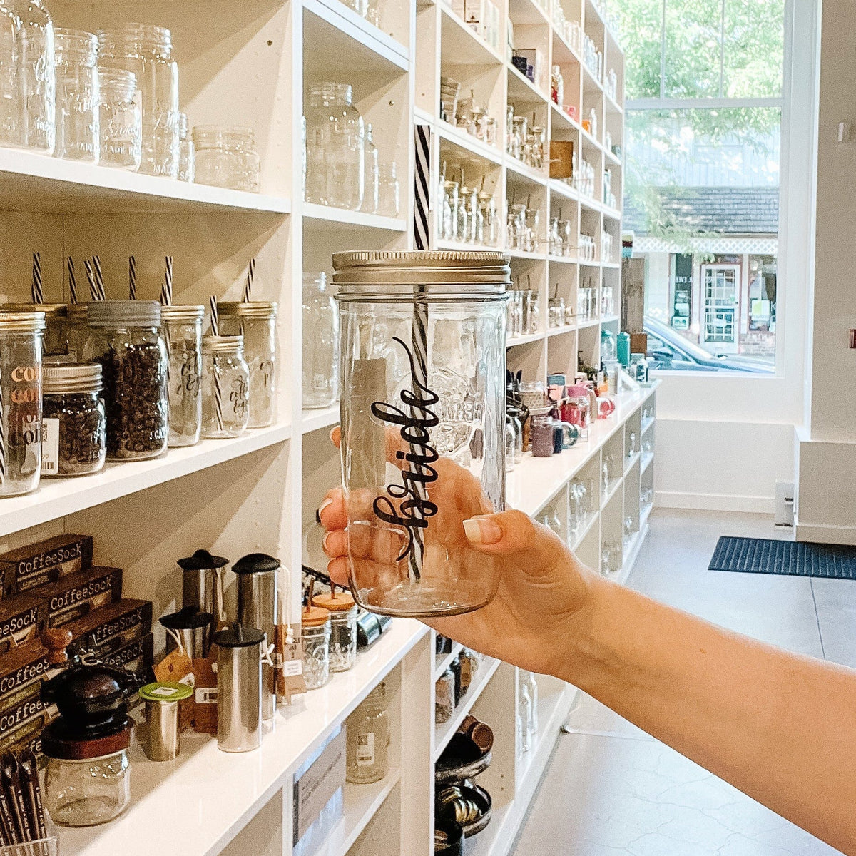 Photo of a mason jar tumbler with a 'Bride' sticker on it.
