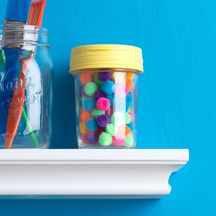 Yellow reCAP 'FLIP' Cap or Mason Jar Flip Top Lid on a mason jar with colorful balls inside on a blue background