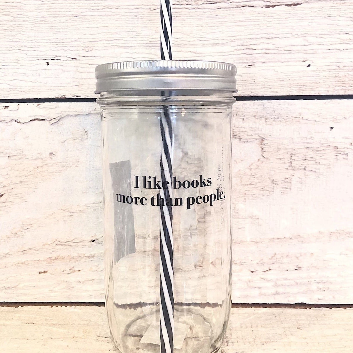 Mason jar tumbler that says "I like books more than people.”