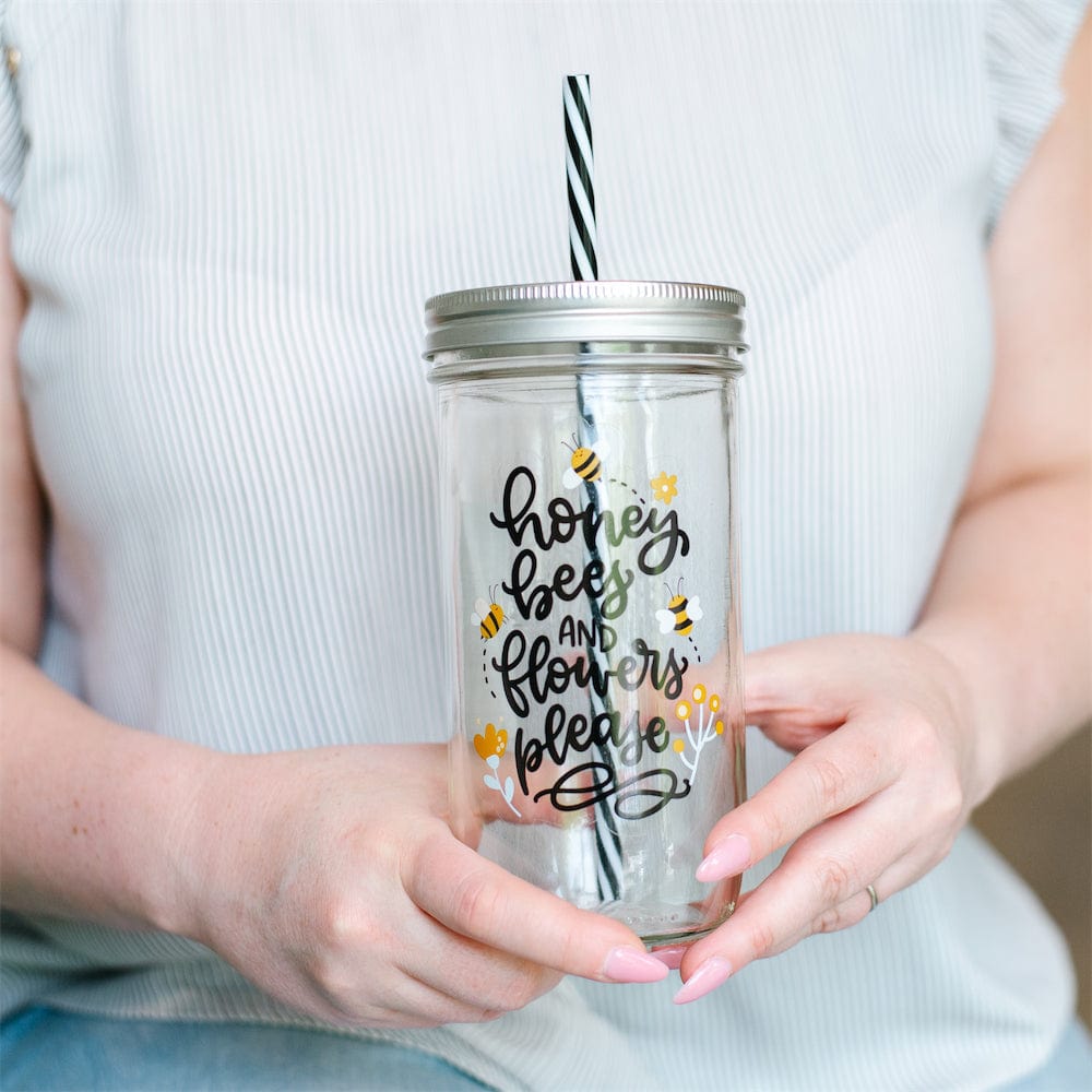 Photo of a mason jar tumbler with a print that says "honey, bees, and flowers please".