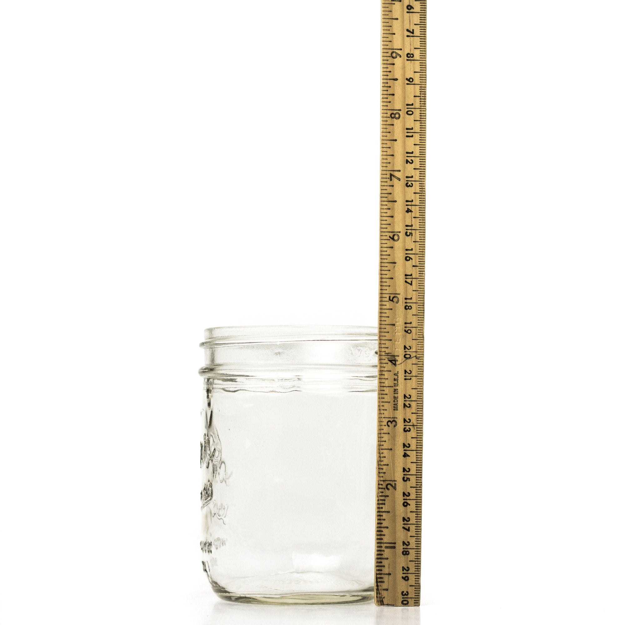 Wide mouth pint mason jar side view with a ruler for height comparison