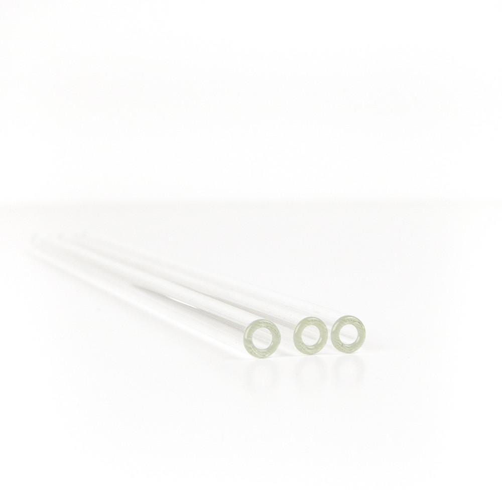 close up of three reusable glass straws on a white background