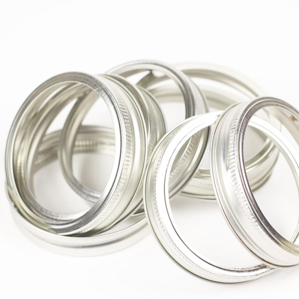 close up of a silver ball wide mouth canning lid on a white background